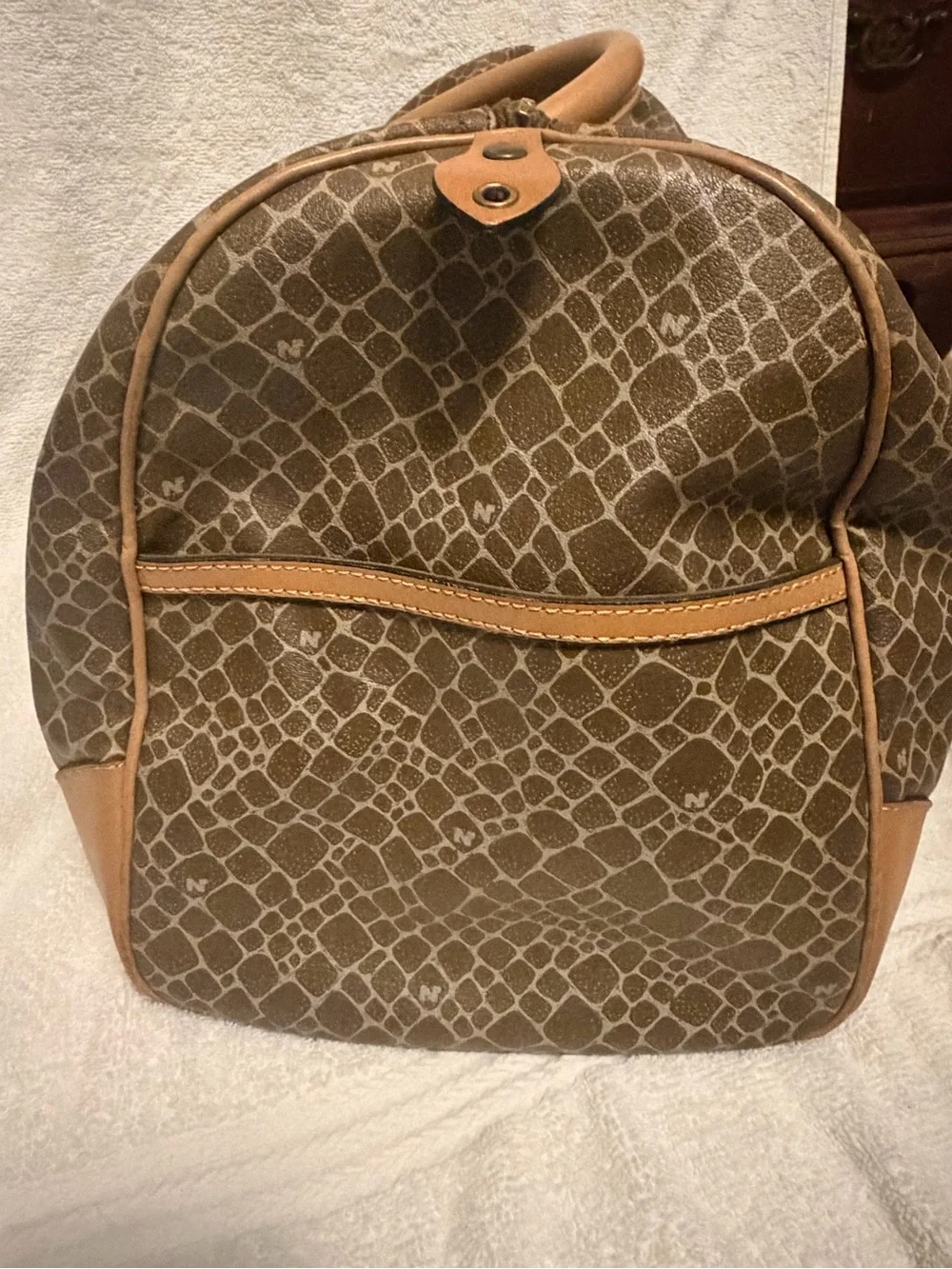 Nina Ricci Brown Patterned Duffel with Tan Trim. Has lock and key.